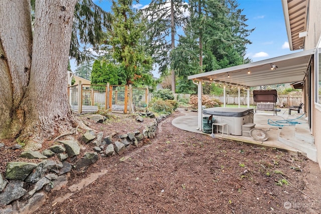 view of yard with a patio, a hot tub, and a storage shed