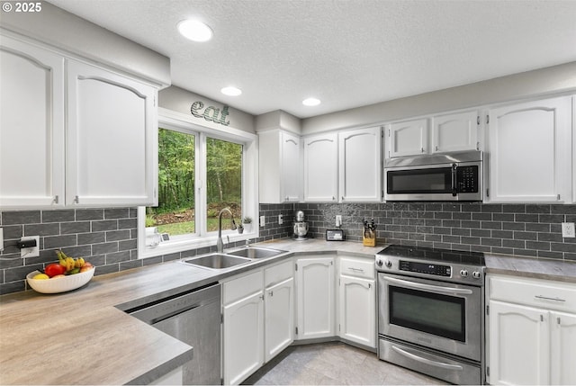 kitchen featuring white cabinets, sink, and stainless steel appliances