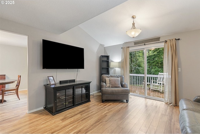 living room with wood-type flooring and vaulted ceiling