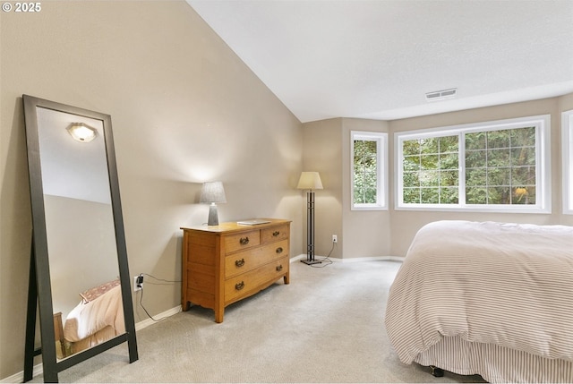 carpeted bedroom with vaulted ceiling