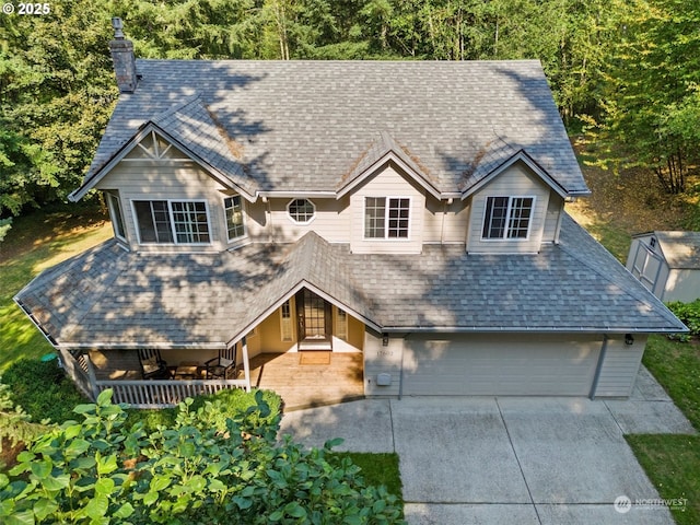 view of front of home featuring a porch and a garage