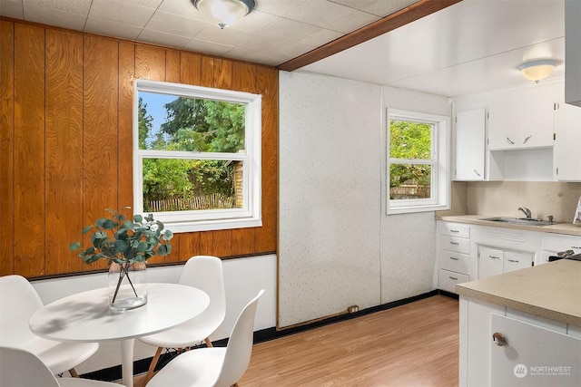 dining room featuring sink and light wood-type flooring