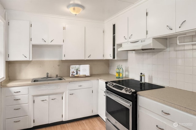 kitchen featuring white cabinetry, stainless steel electric range oven, sink, backsplash, and ornamental molding