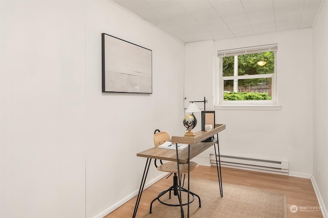 office area featuring baseboard heating and hardwood / wood-style flooring