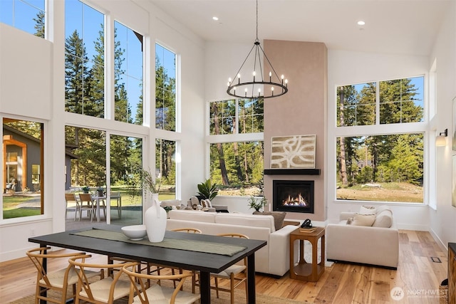 sunroom with plenty of natural light and a chandelier