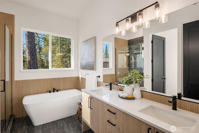 full bathroom with a wainscoted wall, a shower stall, a soaking tub, double vanity, and wooden walls