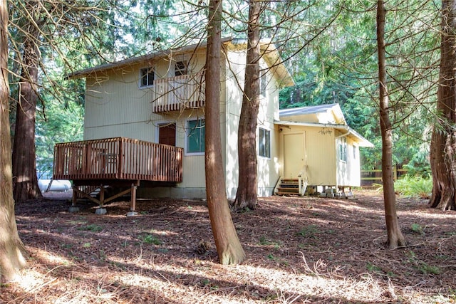 back of house featuring a wooden deck