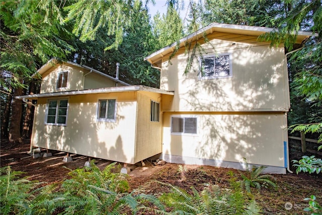 view of property exterior with a storage shed