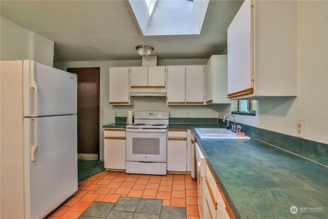 kitchen featuring white appliances, a skylight, white cabinetry, light tile patterned floors, and sink