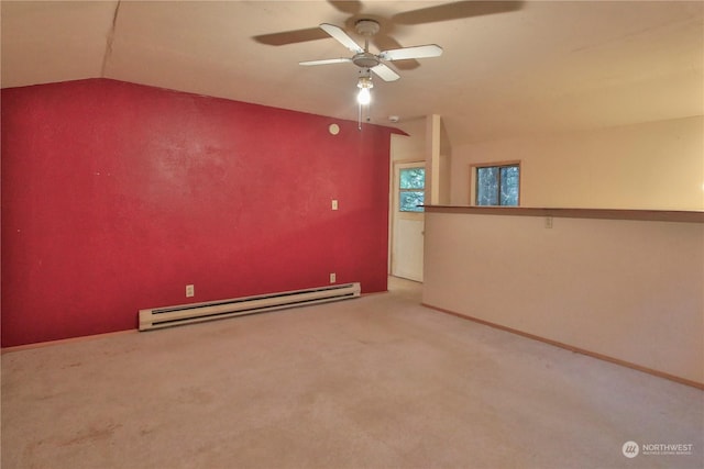 unfurnished room with ceiling fan, baseboard heating, carpet flooring, and lofted ceiling