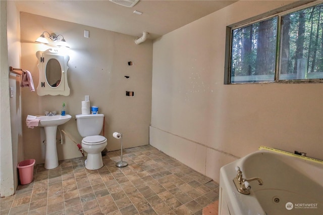 bathroom with toilet and a bath