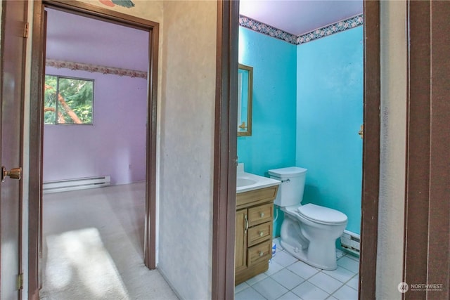 bathroom with baseboard heating, tile patterned floors, toilet, and vanity