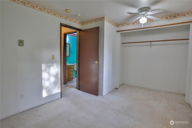 unfurnished bedroom with ceiling fan, a closet, and light carpet