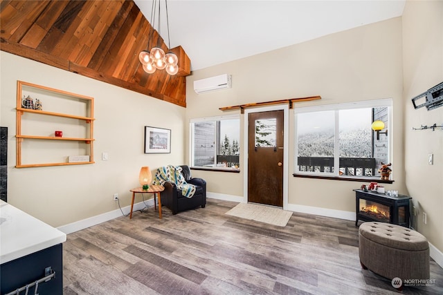 entryway featuring a notable chandelier, high vaulted ceiling, dark hardwood / wood-style floors, and a wall unit AC