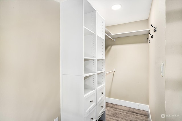 spacious closet with hardwood / wood-style floors