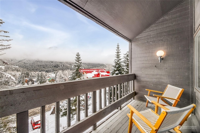 view of snow covered back of property