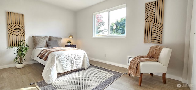 bedroom with wood finished floors and baseboards