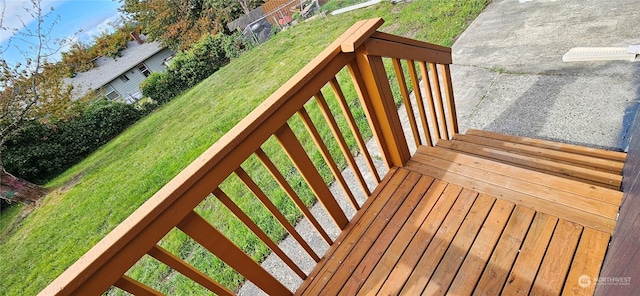 wooden deck featuring a lawn