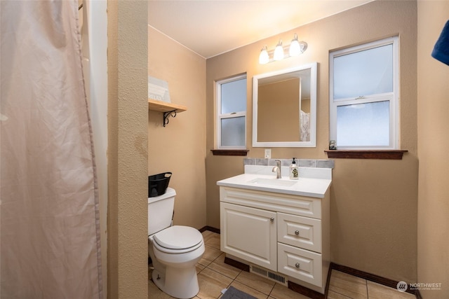 bathroom featuring toilet, vanity, and tile patterned floors