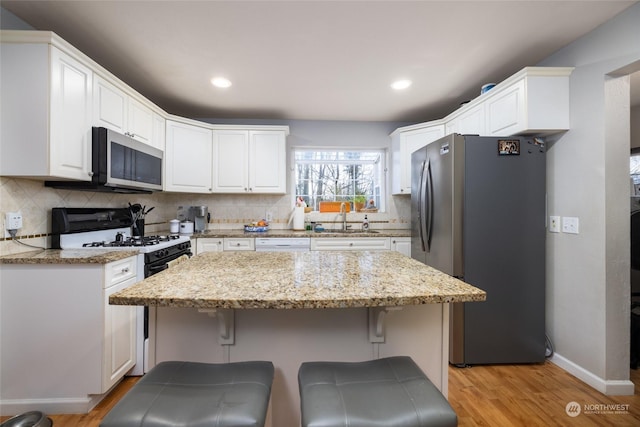 kitchen featuring sink, white cabinets, and appliances with stainless steel finishes