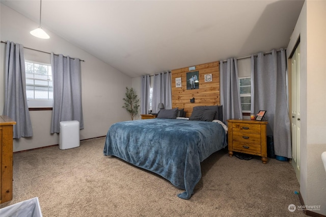 bedroom featuring wooden walls, light colored carpet, and lofted ceiling