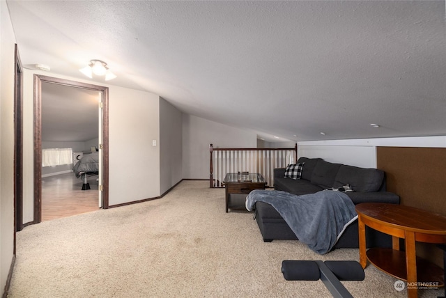 living room featuring a textured ceiling, light colored carpet, and lofted ceiling