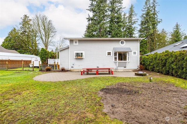 back of property featuring a yard and a patio area