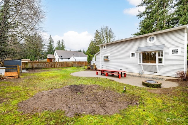 back of house featuring a lawn and a patio