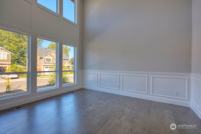 empty room with dark hardwood / wood-style floors