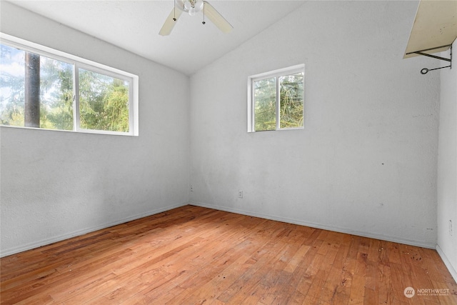 unfurnished room featuring ceiling fan, lofted ceiling, and light hardwood / wood-style flooring