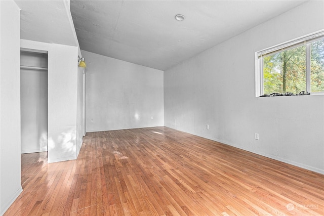 unfurnished bedroom with light hardwood / wood-style floors and a closet