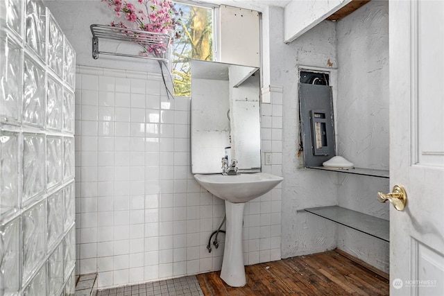 bathroom with tile walls and electric panel