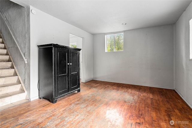 empty room with hardwood / wood-style flooring