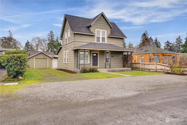 view of front of house with an outbuilding, a garage, a front lawn, and covered porch