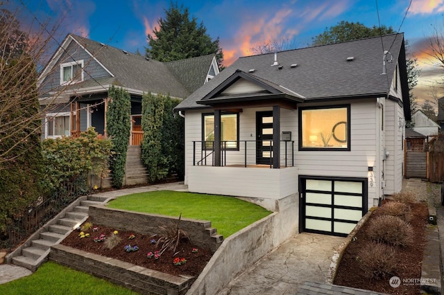 view of front facade featuring a lawn and a garage