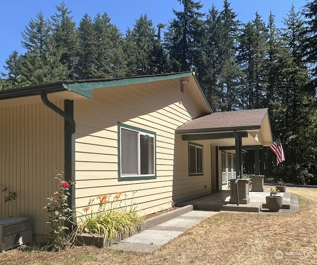 view of side of property with a porch