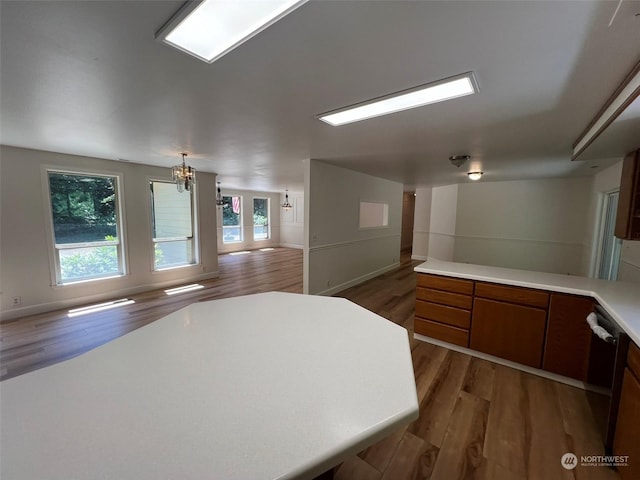 kitchen with dark hardwood / wood-style flooring and a notable chandelier