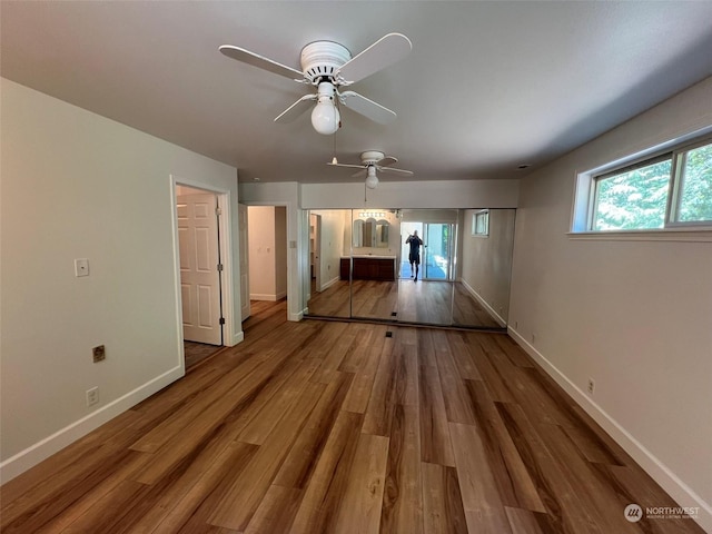 interior space featuring wood-type flooring and ceiling fan