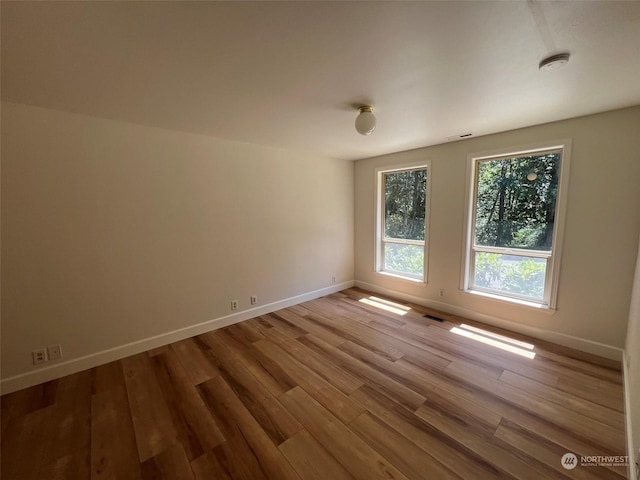 unfurnished room featuring hardwood / wood-style floors