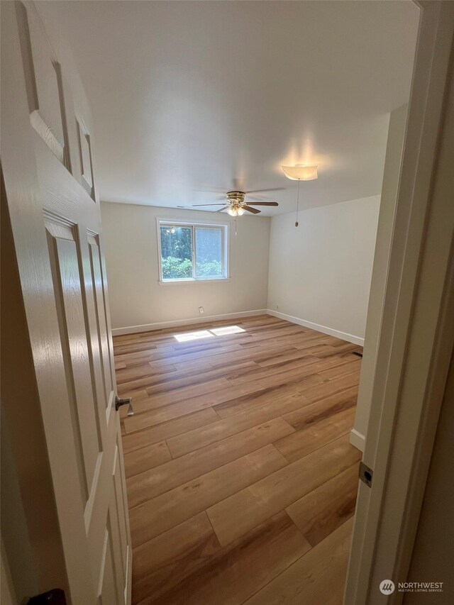 unfurnished room with light hardwood / wood-style flooring and ceiling fan