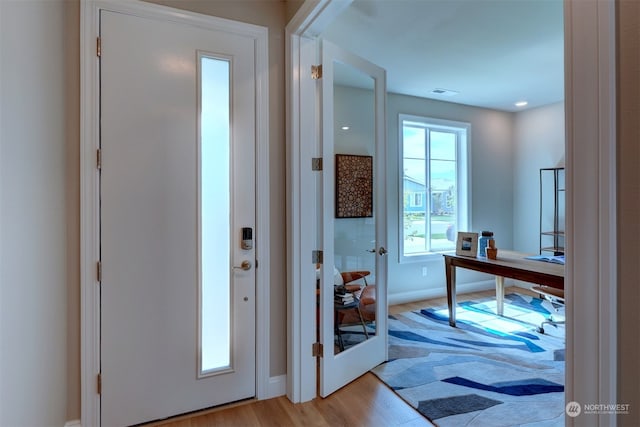 doorway with light hardwood / wood-style flooring