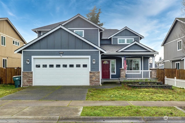 craftsman house featuring a porch, a garage, and a front lawn