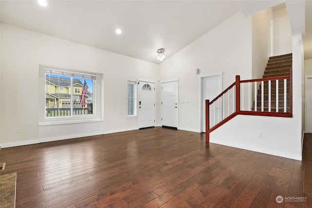 entrance foyer featuring high vaulted ceiling and dark wood-type flooring