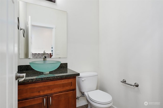 bathroom with tile patterned floors, vanity, and toilet