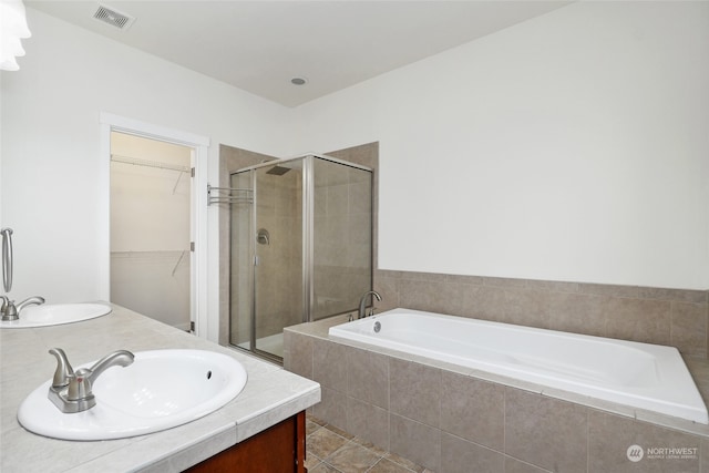 bathroom featuring vanity and separate shower and tub