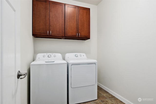 washroom with cabinets and washer and clothes dryer