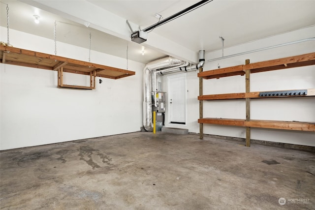 garage with a garage door opener and water heater