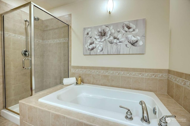 bathroom featuring separate shower and tub