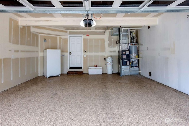 garage with secured water heater, white fridge, and a garage door opener