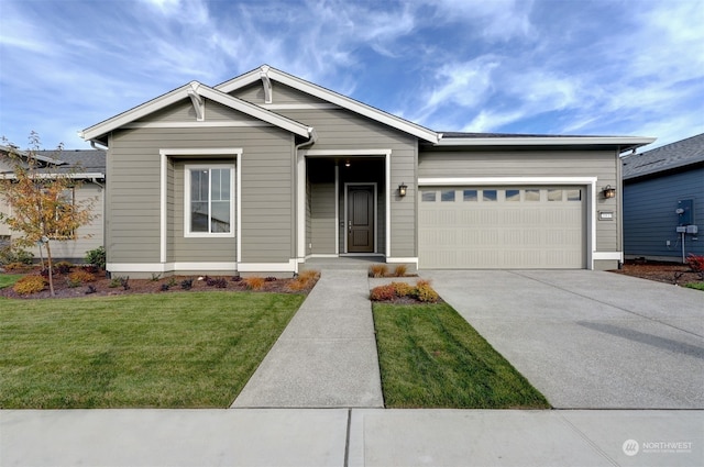 view of front of house with a front lawn and a garage